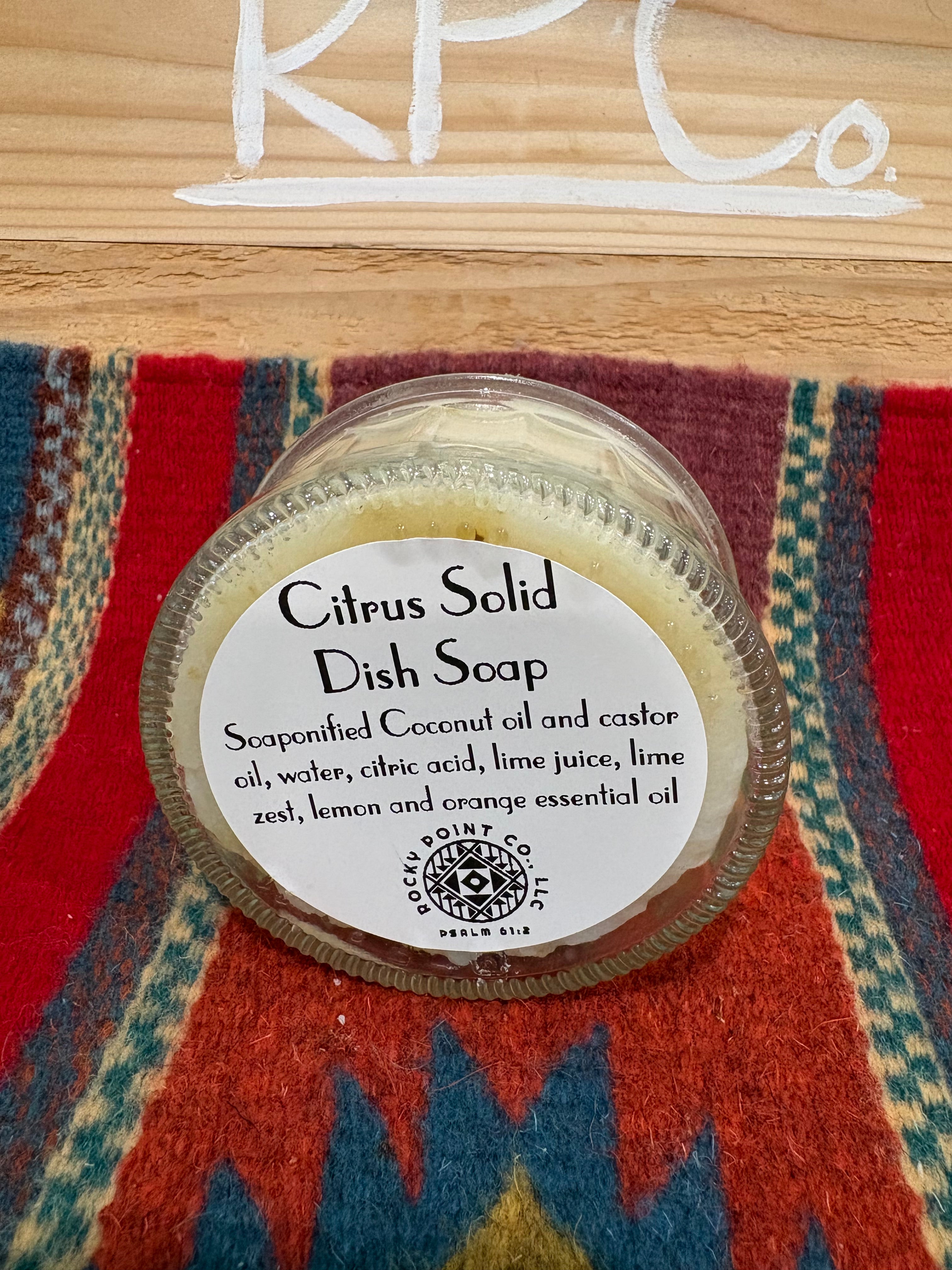 Citrus Solid dish soap container on a patterned fabric background